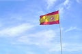 Spain flag waving in the wind on flagpole against the sky with clouds Royalty Free Stock Photo