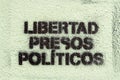 Political graffiti, in the Catalan language, stenciled onto the ground. calling for freedom for political prisoners. in the town o Royalty Free Stock Photo