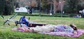 Spain guy is resting lying on the lawn, next to the bike and suitcase. Relaxation