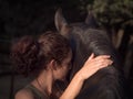 Spain, Horizontal backview of female forming bond with andalusian mare.