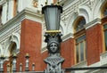 Spain, Madrid, metal streetlight with a head Royalty Free Stock Photo