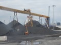 Spain: mountains of charcoal at Tarragona\'s harbour