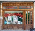 Spain; Sept 2020: Exterior of a dry cleaning store. Old wooden door and windows. Traditional shop with red letters on the glass. Royalty Free Stock Photo