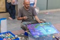 Spain, Seville, May, 3, 2017. Airbrush painter painting a beautiful abstract picture on the street during the Seville Fair