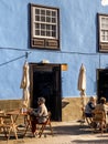 Street view with beautiful ancient houses and people sitting on the cafe