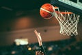 Female basketball player put the ball into the hoop to score points. Royalty Free Stock Photo