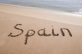 Spain title on the sand beach near the ocean