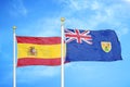 Spain and Turks and Caicos Islands two flags on flagpoles and blue cloudy sky