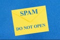 SPAM warning do not open message on white envelope on blue