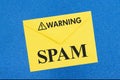 SPAM warning message on white envelope on blue