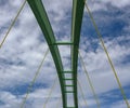 Span of an arched bridge against a blue sky with clouds