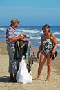 Beach trader and woman on the beach, Marbella, Spain. Royalty Free Stock Photo