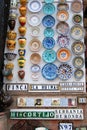 Colourful ceramic plates and pots on a shop wall, Ronda, Spain.