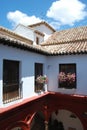 Elevated view of archways and balconies in the Mondragon Palace courtyard, Ronda, Spain.