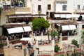 Tourists relaxing at a pavement cafe overlooking the gorge, Ronda, Spain.