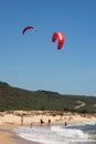 Tourists and kite surfers on Trafalgar beach, Spain.