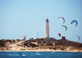 Kitesurfers and lighthouse at Cape Trafalgar, Spain.