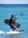 Kite surfer holding a surfboard, Trafalgar, Spain.