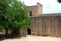 View of part of the old town defence wall with a doorway and tower, Ronda, Spain.