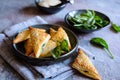 Spanakopita triangles stuffed with spinach and Feta cheese