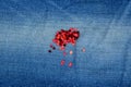 Spangles red scattered on a jeans background close-up Royalty Free Stock Photo
