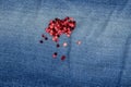 Spangles red scattered on a jeans background close-up Royalty Free Stock Photo