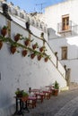 Spanish architecture style buildings with whitewashed walls and flower pots on the walls Royalty Free Stock Photo