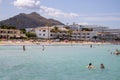 The Spanish beach taken on the beautiful island of Majorca in Spain showing people relaxing and having fun on the beach in the