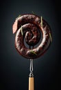 Spanish black pudding or blood sausage with rosemary on a fork