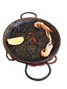 Spanish black squid ink paella with lobsters and scallops isolated. Classical Spanish cuisine Royalty Free Stock Photo