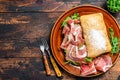 Spanish bocadillo de jamon, serrano ham sandwich on ciabatta bread with arugula. Dark wooden background. Top view. Copy Royalty Free Stock Photo