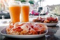 Spanish breakfast with bread, ham and papaya and orange juice