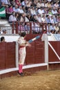 Spanish bullfighter Juan Jose Padilla jumping and suspended in the air with two banderillas in the right hand looking at the bull