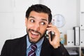 Spanish businessman is excited while talking phone