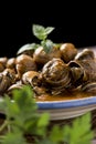 Spanish caracoles en salsa, cooked snails in sauce Royalty Free Stock Photo