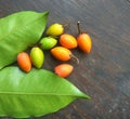 Spanish cherry with leaves on wooden board.