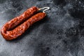 Spanish chorizo pork cured sausage. Black background. Top view. Copy space