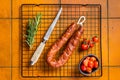 Spanish Chorizo sausage, dry cured pork with herbs and spices. Orange background. Top view Royalty Free Stock Photo