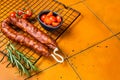 Spanish Chorizo sausage, dry cured pork with herbs and spices. Orange background. Top view. Copy space Royalty Free Stock Photo