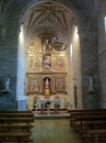 A Spanish church interior with pews and altar.