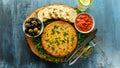 Spanish classic tortilla with potatoes, olives, tomatoes, rucola, bread and herbs.