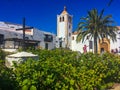 Spanish colonial church square and palm tree on canary islands