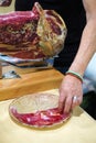 Spanish cuisine. Ham cutter preparing a delicious plate of Iberian ham Royalty Free Stock Photo