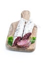 Spanish dry cured sausages salami with parsley and spices on wooden board Royalty Free Stock Photo