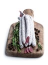 Spanish dry cured sausages salami with rosemary and spices on wooden board Royalty Free Stock Photo