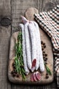 Spanish dry cured sausages salami with rosemary and spices on wooden board Royalty Free Stock Photo