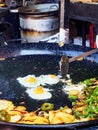 Spanish eggs with potatoes and peppers to the frying pan. Royalty Free Stock Photo