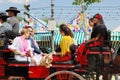 Spanish family in horse drawn carriage.