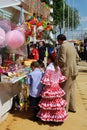 Spanish family at a snack and toy stall.