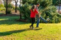 Spanish father and pre-adolescent daughter playing sports laughing in the park, they are playing soccer and having a